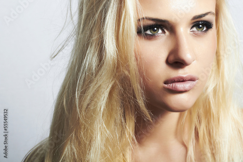 Beautiful blond woman with disheveled hair.make-up