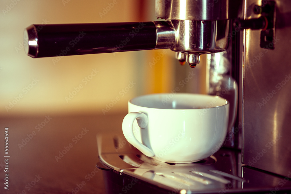 prepares espresso in his coffee shop; close-up prepares espresso in his coffee shop; close-up