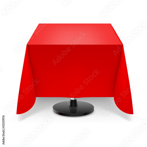 Square table with red tablecloth.