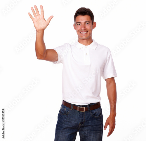 Smiling young man with a greeting hand gesture