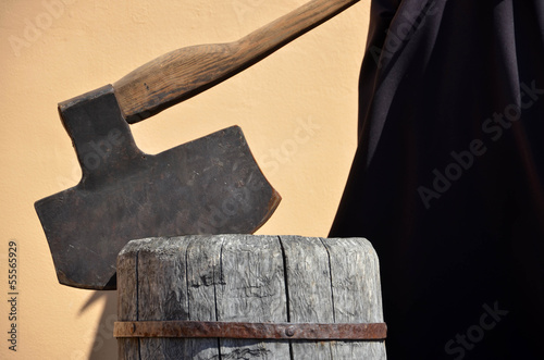 Headsman's axe hewed in old wooden chunk