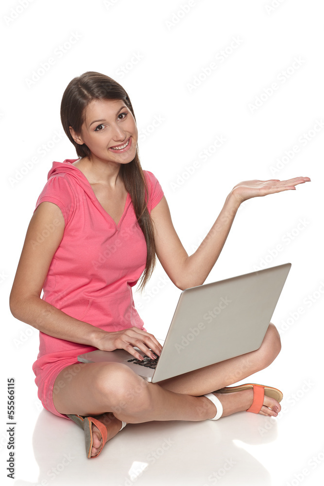 Smiling female with laptop showing copy-space on palm Smiling female with laptop showing copy-space on palm