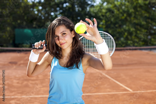 Beautiful girl smiling with a tennis racket