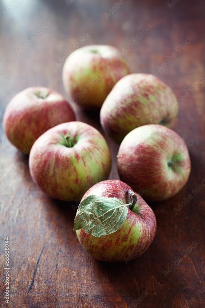 Ripe red apples on a old wooden table . Ripe red apples on a old wooden table .