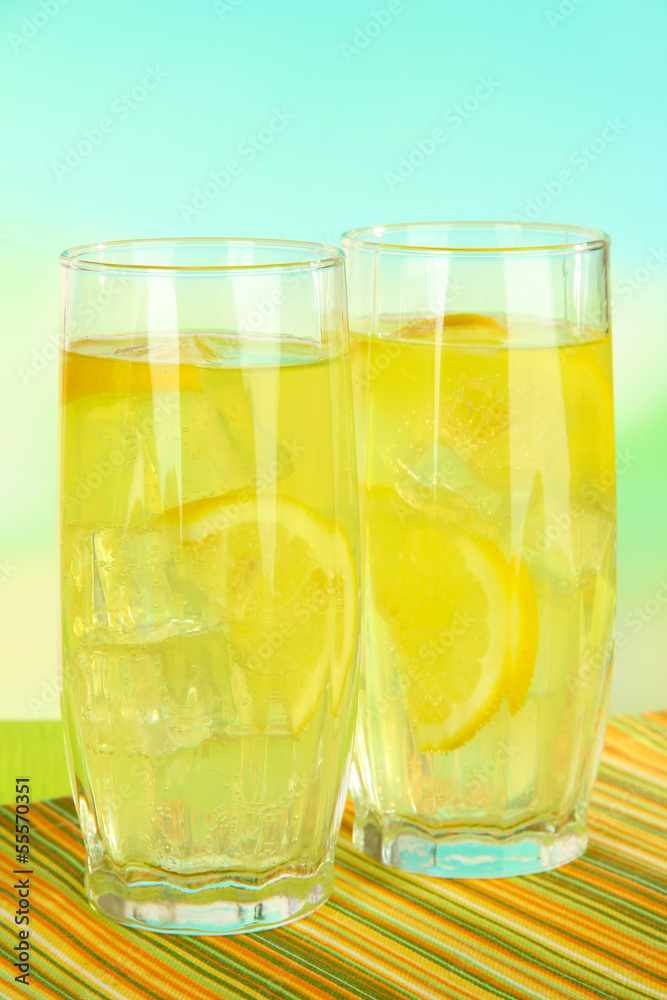 Delicious lemonade on table on light blue background