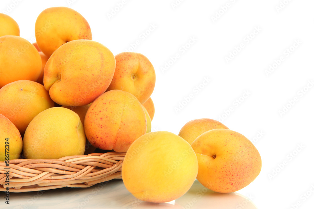 Fresh natural apricot in wicker basket isolated on white Fresh natural apricot in wicker basket isolated on white