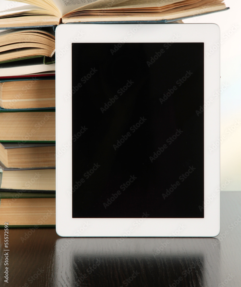 Tablet and books on light background Tablet and books on light background