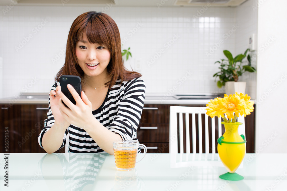 young asian woman relaxing in the kitchen young asian woman relaxing in the kitchen