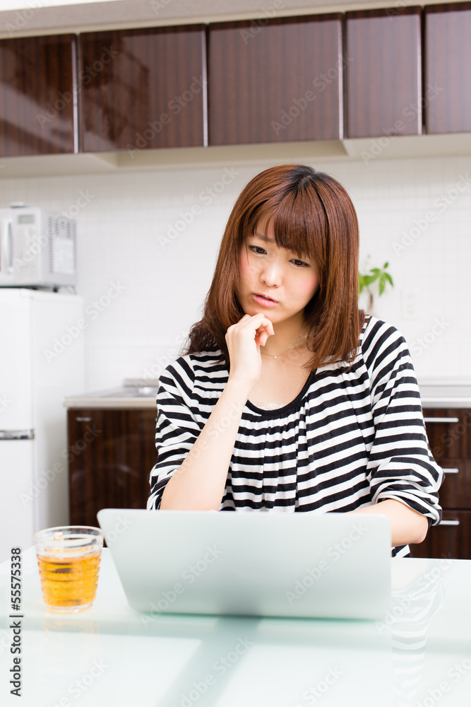 young asian woman relaxing in the kitchen young asian woman relaxing in the kitchen