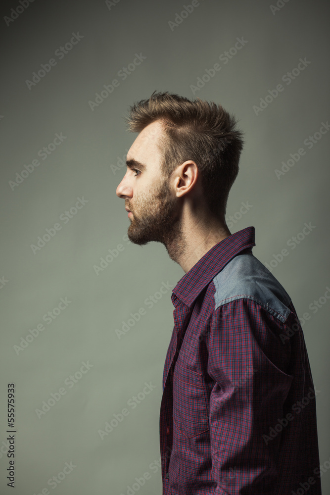 Fototapeta premium Young adult man on a dark background
