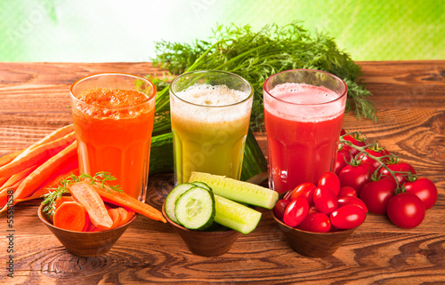 tomato, carrot and cucumber fresh drinks on wood