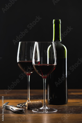 Two glasses of red wine and bottle