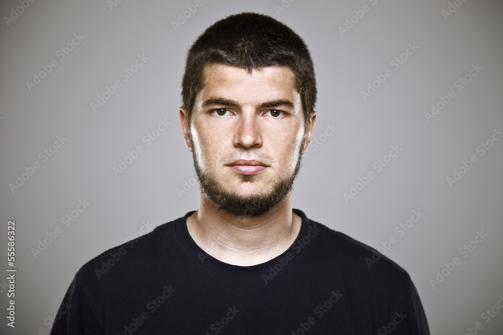 Portrait of a real man over grey background.
