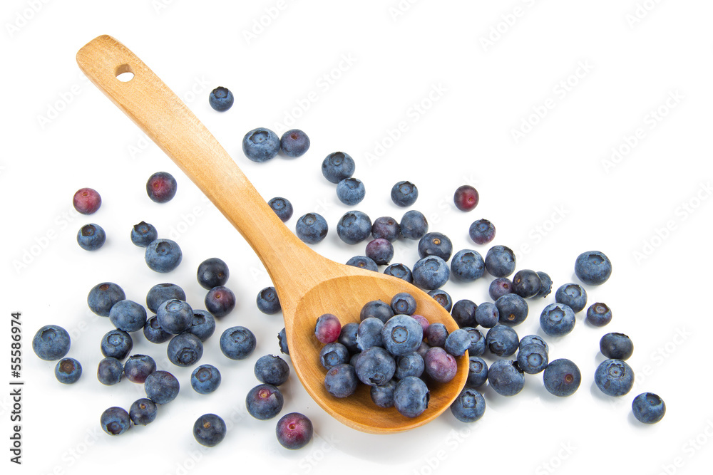 The composition of the blueberries in a wooden spoon The composition of the blueberries in a wooden spoon
