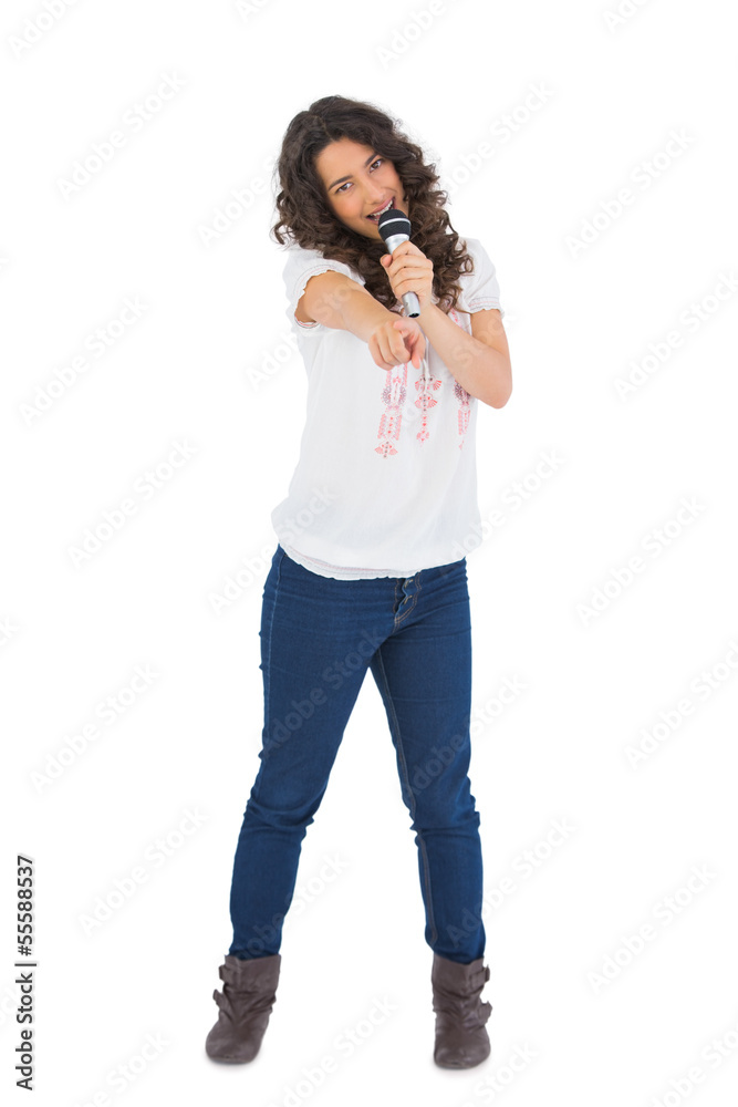 Pretty brunette singing with her microphone Pretty brunette singing with her microphone