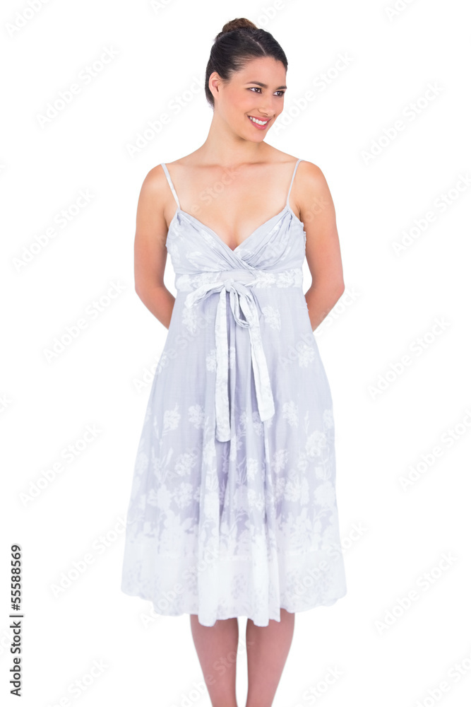 Cheerful seductive young model in summer dress posing