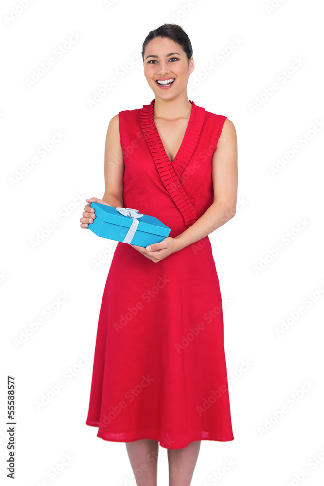 Happy glamorous model in red dress holding present Happy glamorous model in red dress holding present