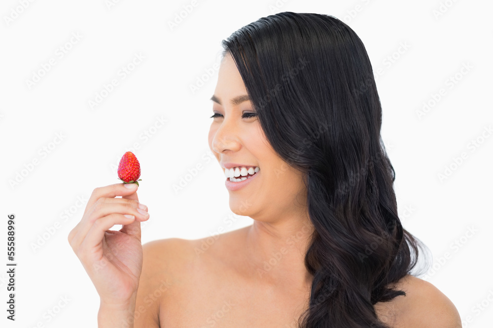 Happy natural brown haired model with strawberry Happy natural brown haired model with strawberry
