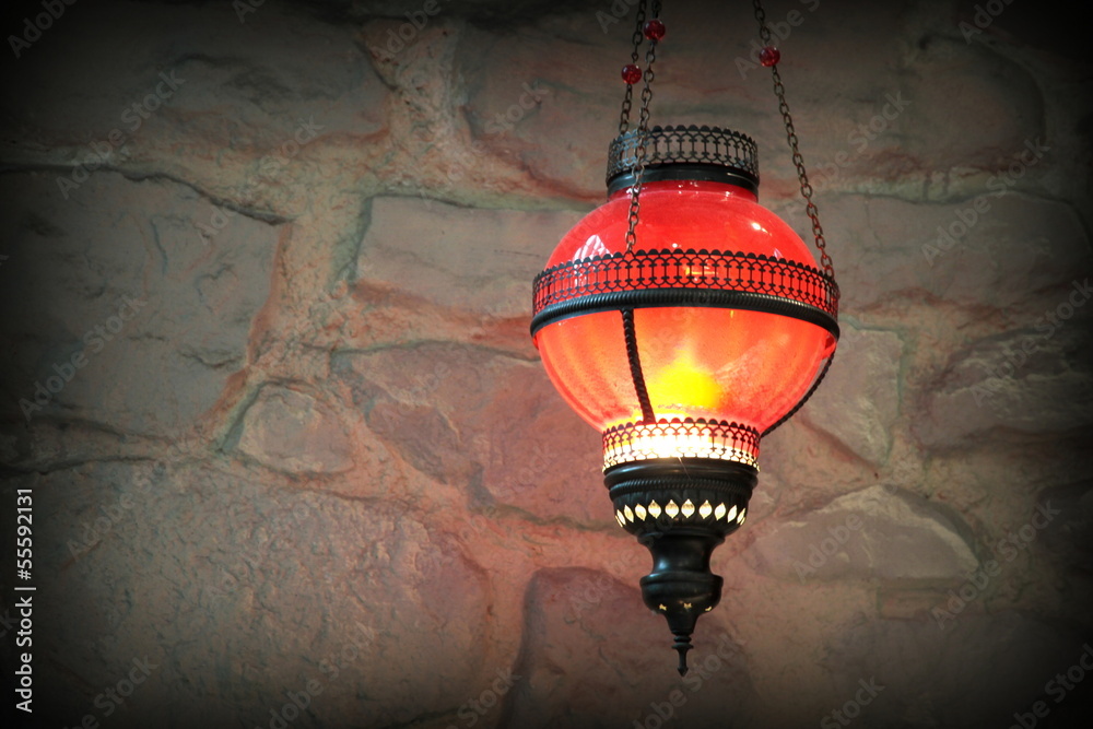Obraz premium Metal lantern on a old stone wall