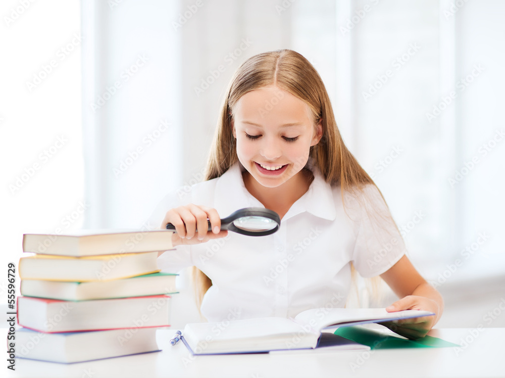 girl reading book with magnifier at school girl reading book with magnifier at school