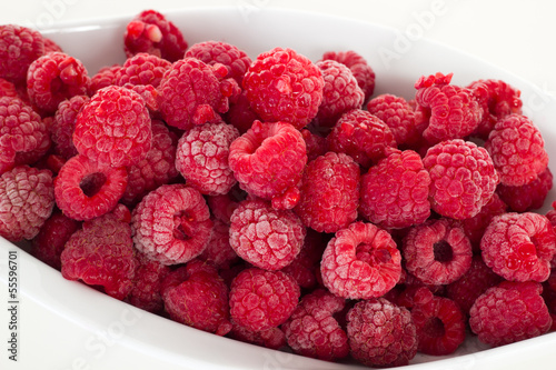 Frozen raspberries in white dish photo