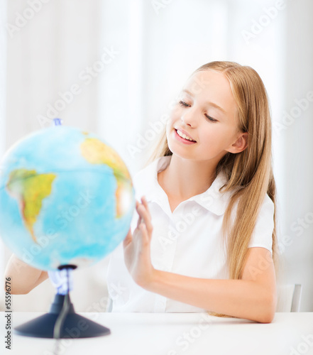 student girl with globe at school