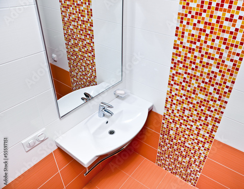 Clean home bathroom with sink and mirror