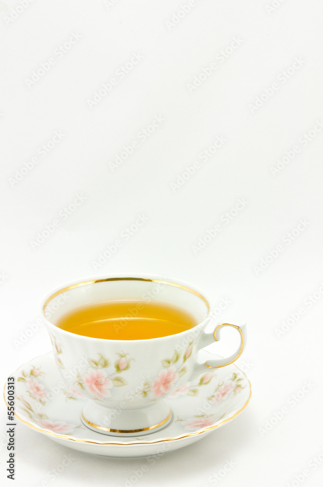 porcelain tea cup full of tea on a white background porcelain tea cup full of tea on a white background