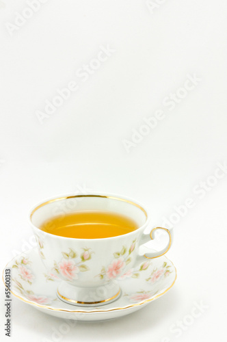 porcelain tea cup full of tea on a white background