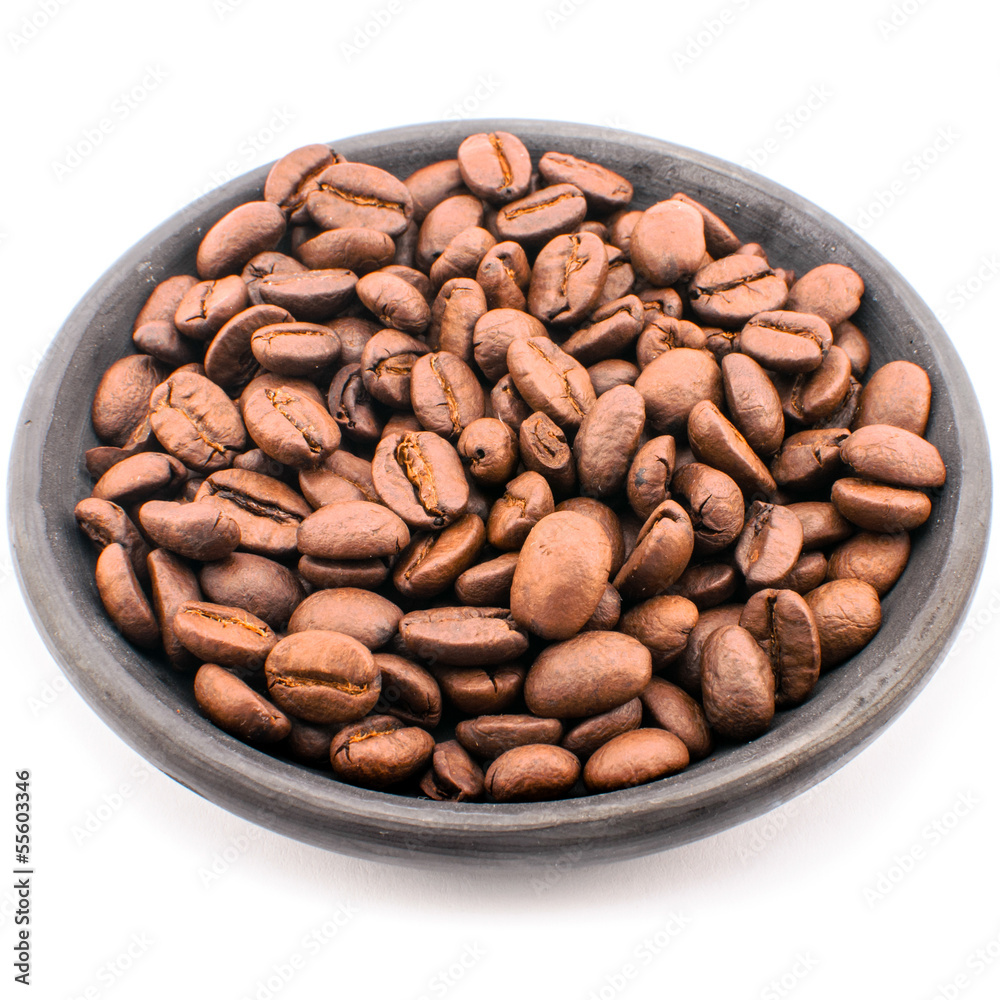Coffee beans on black saucer. Coffee beans on black saucer.