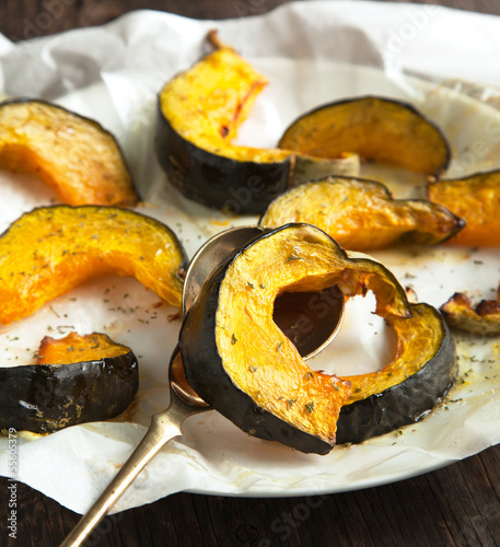 Baked pumpkin slices with herbs and olive oil