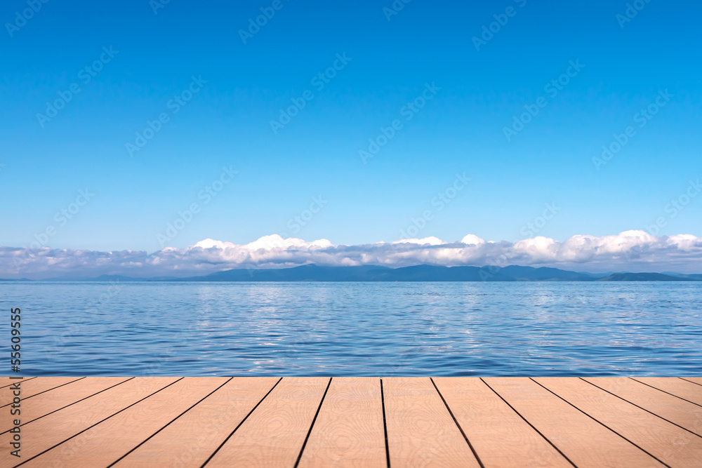 Seascape under blue sky. View from wooden pier.