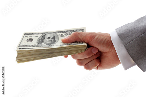 hand of businessman holding pile of dollars