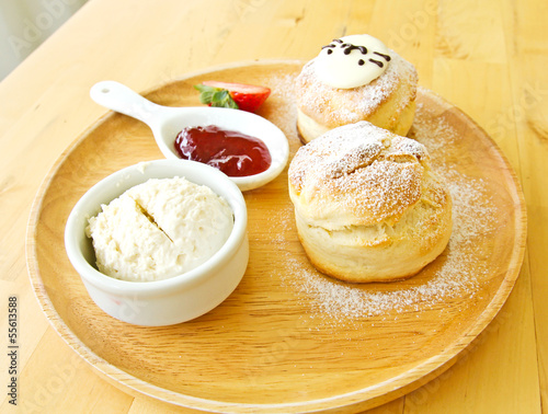 Scone spread with cream and...