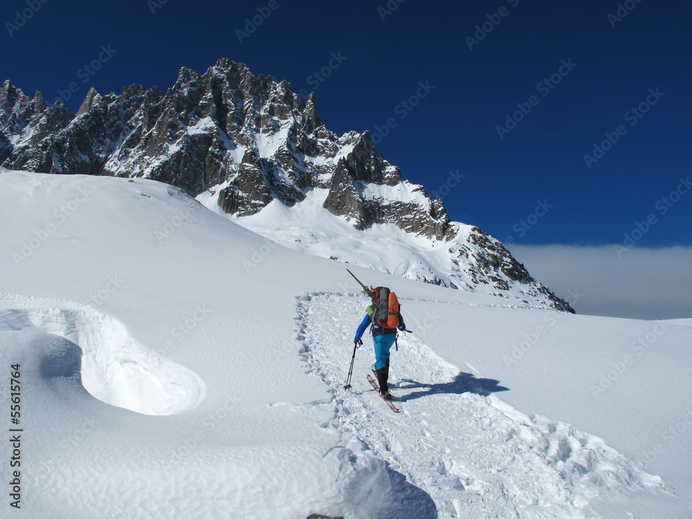 Young man doing ski touring in winter Alps