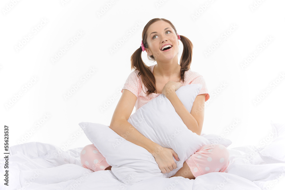 Teenage dream. Beautiful young woman sitting on the sofa and hug Teenage dream. Beautiful young woman sitting on the sofa and hug