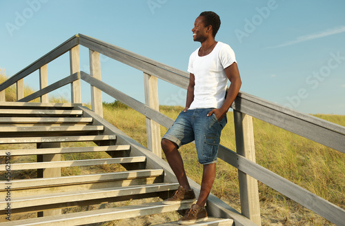 Fototapeta Naklejka Na Ścianę i Meble -  Attractive african american male smiling outdoors