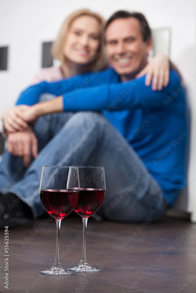 Romantic moments. Beautiful middle aged couple sitting on the fl