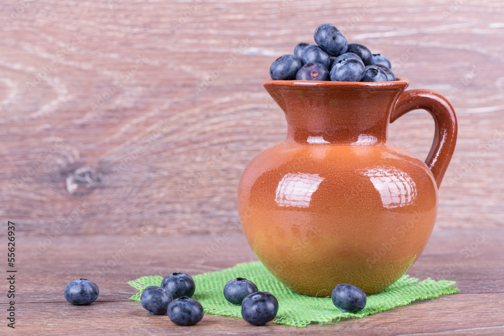 blueberries in a clay jug