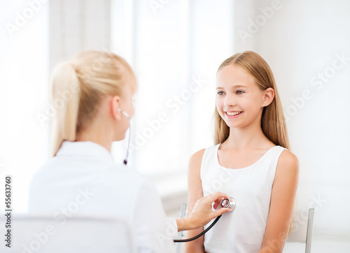 doctor with stethoscope listening to the patient