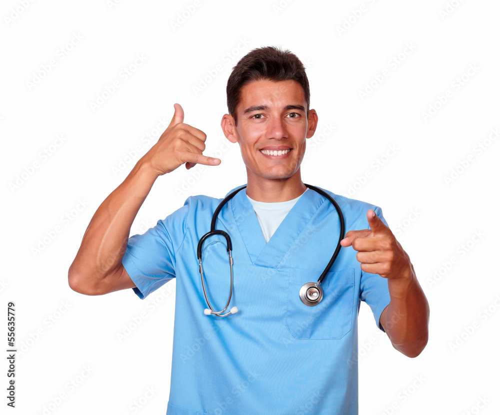 Hispanic handsome nurse gesturing a call with hand Hispanic handsome nurse gesturing a call with hand