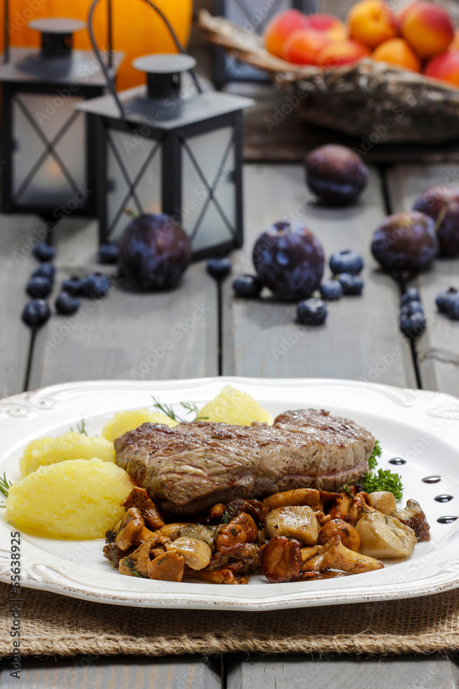 Roasted beef with mushrooms in autumn setting. Selective focus