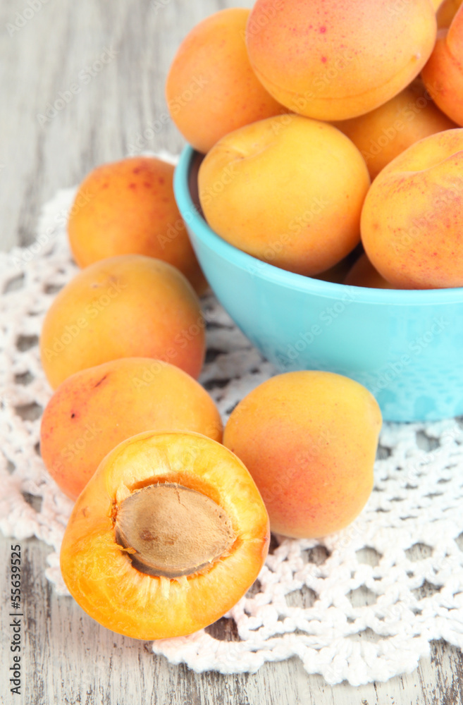 Fresh natural apricot in bowl on green wooden table Fresh natural apricot in bowl on green wooden table