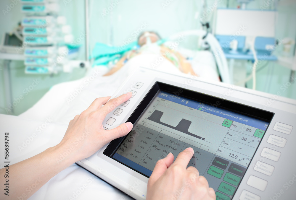Touchpad in the hospital. The doctor adjusts the parameters of t Touchpad in the hospital. The doctor adjusts the parameters of t
