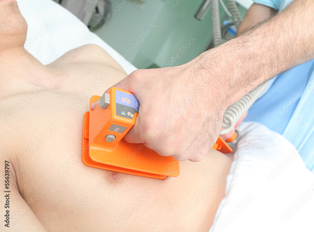Doctor makes the patient an electric defibrillation