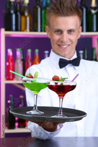 Portrait of handsome barman with different cocktails cocktail 