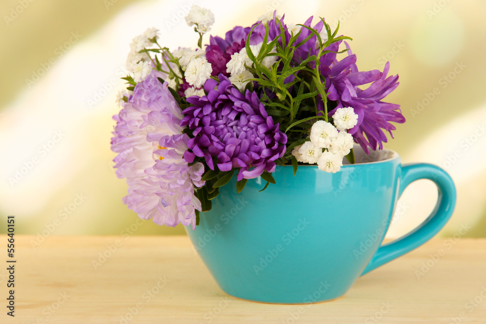 Beautiful bouquet of bright flowers in color mug,