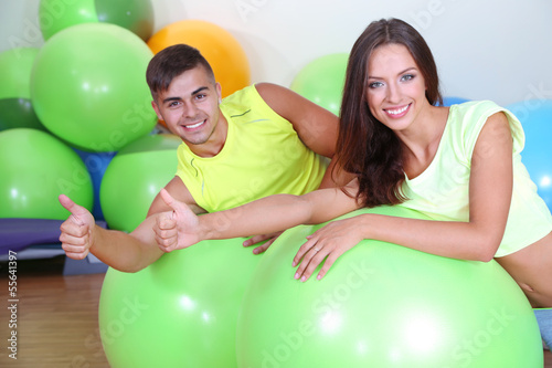 Girl and guy in fitness room