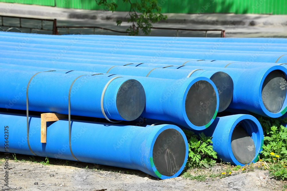 Stacked blue PVC pipe on construction site Stacked blue PVC pipe on construction site