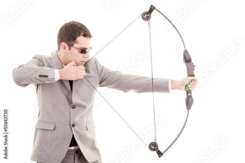 Determined handsome businessman aiming at target with bow